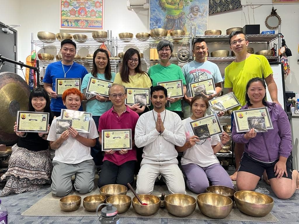 A group of international course graduates with their certificates