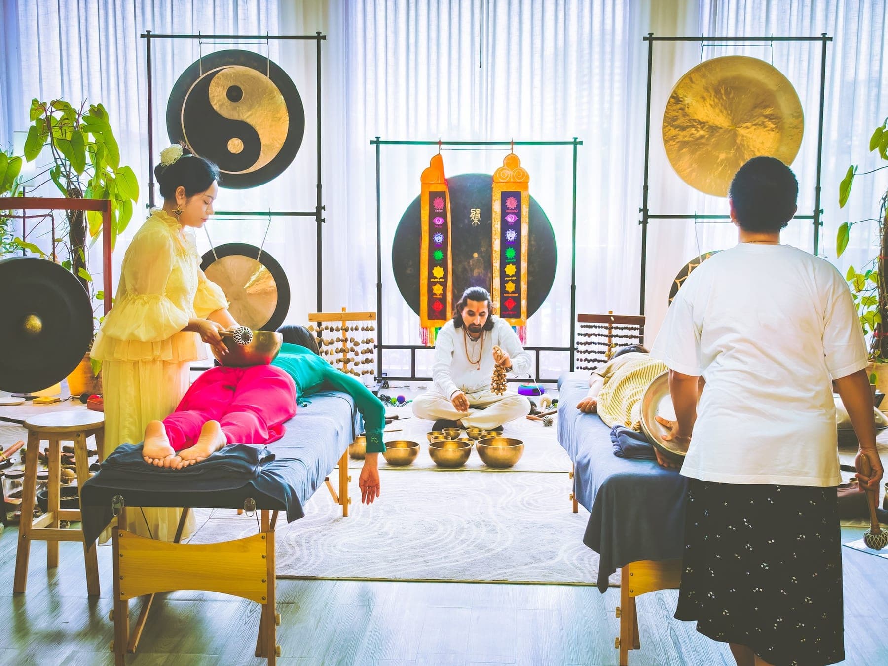A group sound healing session with singing bowls and gongs